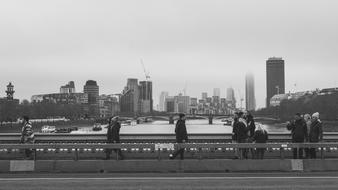 people on Westminster Bridge at winter in view of city, uk, england, London