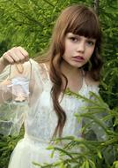 pretty child girl with Candle near Spruce