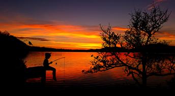 Boy Fish at red sunset