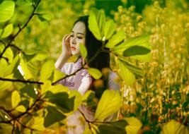 young asian girl in green thickets