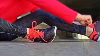 Close-up of the colorful girl's legs with the colorful fitness shoes and clothing