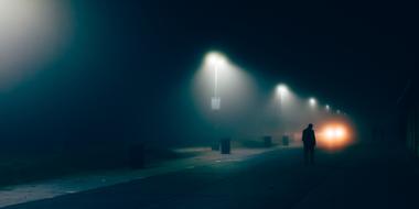 Man on the empty street with the lights