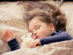 Baby Girl Sleeps with toy bunny