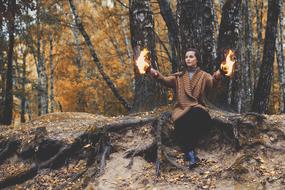 fire in the hands of a girl in the forest