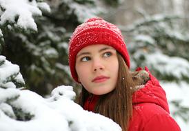 young girl in red in a winter landscape