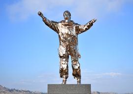 golden sculpture of an astronaut in the valley of the temples, sicily