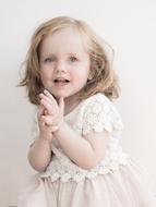 cute girl in a white dress on a bright white background