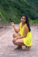 girl in a yellow dress with sunglasses among nature