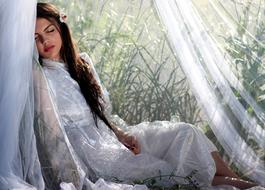 beautiful Girl sleeping beneath White Veil outdoor