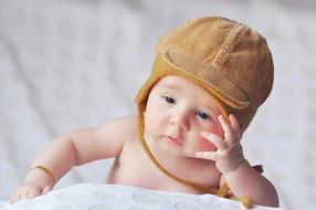 baby in a brown hat