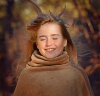 dreamy little girl on the background of autumn blurred landscape