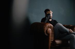 sad man on the couch