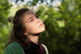 portrait of a pensive girl on a blurred background of nature