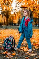 schoolgirl in colorful autumn park