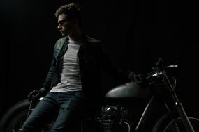 young man with motorcycle in Darkness