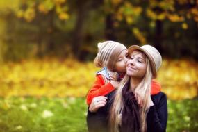 The Child With His mother in Park at Autumn