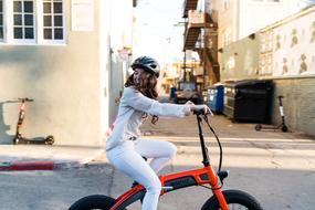 girl on Folding E-Bike Cycling on a city street