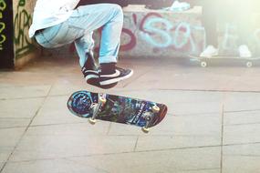 photo of a guy jumping on a skateboard