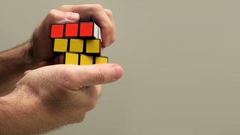 rubik's cube in the hands of a man