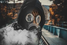 photo of a man in a gas mask on the street