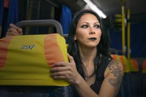 girl with a tattoo rides on a bus