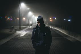 young Man walking in city at night