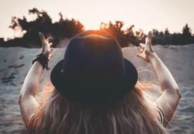 back view of female person in black hat