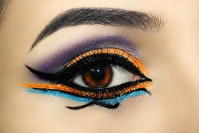 face art, colorful painting around female eye