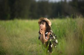 girl in a black and white dress in a meadow