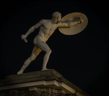 sculpture of a roman warrior with a shield
