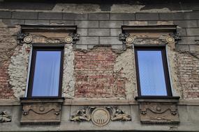 facade with old plaster around the windows