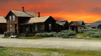 wooden building under orange sky during sunset