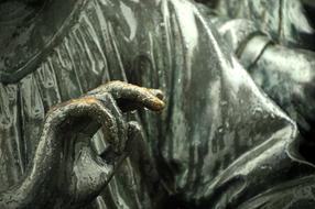 closeup picture of the hand of a bronze sculpture
