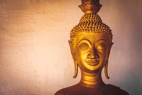 portrait of the the head of gold Buddha Asian statue in Laos