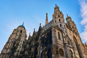 beautiful Vienna St Stephan on background of blue sky with white clouds