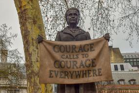 Beautiful statue of Millicent Fawcett with the banner in London, England, UK