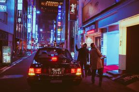 people and taxi cab on street in city at Night, Japan, Osaka