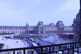 facade of Louvre Palace on snowy winter, France, Paris