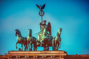 bronze quadriga at top of Brandenburg Gate at sky, germany, Berlin