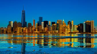 Beautiful shore of Manhattan with colorful lights, at blue sky on background, in New York, USA