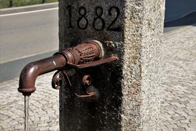 water flows from an antique old faucet
