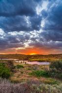 Beautiful landscape of the river in Byron Bay at colorful sunset in clouds in Australia