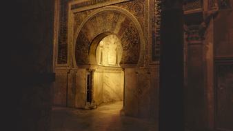 aged ornate stone carved Arch in moorish interior