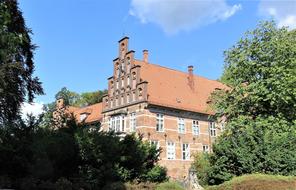 Beautiful castle in the mountain village in Hamburg, among the colorful plants, in Germany