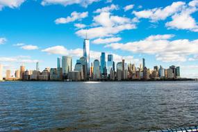 Beautiful New York City with the coast, against the blue sky with white clouds