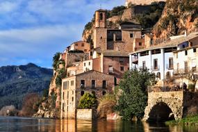Beautiful landscape of the colorful town on the rocky shore of the river in Spain