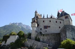 castle with flags among a picturesque landscape on a sunny day