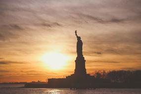 Statue Of Liberty on the background of a raging colorful evening sky