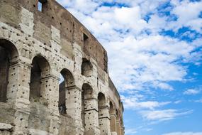 blue sky with white clouds over the colosseum