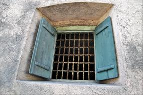 Old window with the blue shutters in the monument, near the Lake Dusia, Lithuania